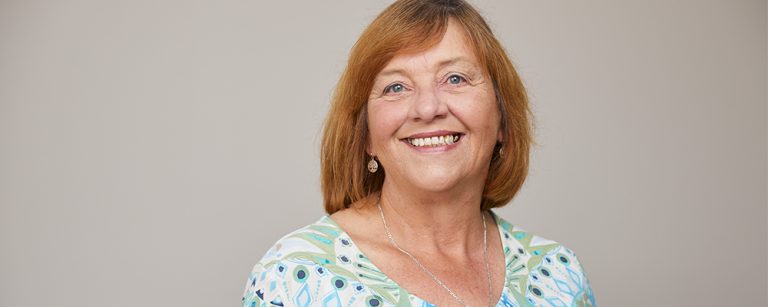 A head shot of pauline smiling
