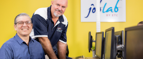 Career transition assistance customer in training room with etc staff