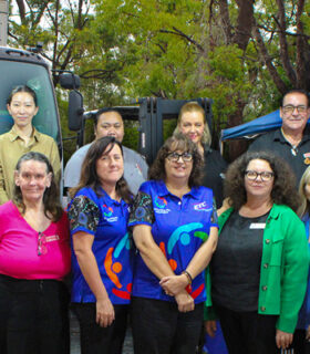 New Life Foodbarn volunteers and community representatives gathered outside the Arundel Foodbarn